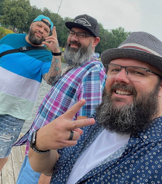 Three men with beards and hats posing for a Smokey Bourbon Beard Oil by Mountaineer Brand Products, organic, all-natural photo.