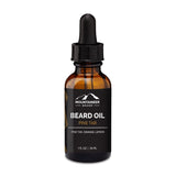 Amber glass bottle of Mountaineer Brand Products Natural Beard Oil with dropper, labeled "pine tar, orange, lemon essential oils, 1 fl oz, 30 ml" against a white background.