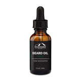 A bottle of Mountaineer Brand Products Natural Beard Oil labeled "Timber" with cedar, fir, and eucalyptus essential oils, 1 fl oz (30 ml), with a dropper