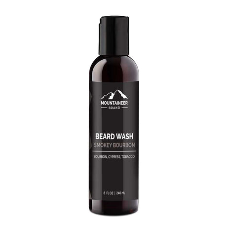 A bottle of Mountaineer Brand Products Beard Wash labeled "smokey bourbon" with bourbon, cypress, and tobacco scents, featuring natural ingredients, 8 fl oz (240 ml).