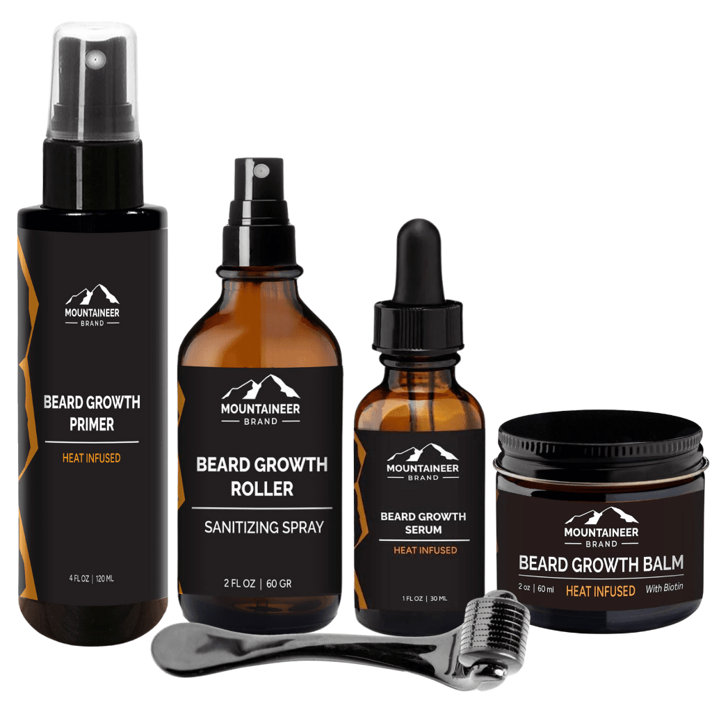 Four Essential Beard Growth System products from Mountaineer Brand Products for beard growth, including a spray, Beard Growth Serum, micro-needling sanitizing roller, and balm, displayed against a white background.
