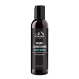 A black bottle of Mountaineer Brand Products Natural Beard Conditioner labeled "White Water" with scent notes of mint, cedar, and musk, 8 fl oz size.