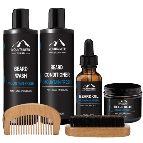 A comprehensive grooming kit for maintaining a well-groomed beard, featuring The Starter Beard Kit by Mountaineer Brand Products, which includes a beard brush, beard oil, and beard conditioner.