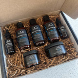 A box containing The Complete Bald Head Care System + 2 Free Shave Oils for pH balance and shine, including items for a bald head from Mountaineer Brand Products.