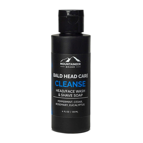A bottle of Mountaineer Brand Products's Bald Head Cleanse soap, made with natural ingredients including peppermint, cedar, rosemary, and eucalyptus.