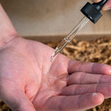 A person pouring a liquid into their hand from the Mountaineer Brand Products Best Sellers Kit.