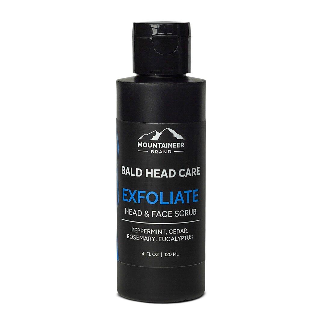 A bottle of Mountaineer Brand Products Bald Head Exfoliater for head and face, with natural ingredients such as peppermint, cedar, rosemary, and eucalyptus.