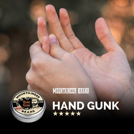 A man is holding a tin of Mountaineer Brand Products' Hand Salve.