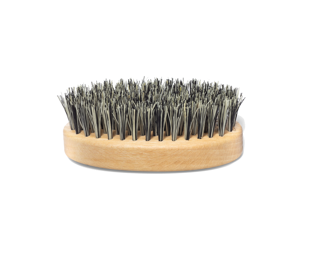 An all-natural Premium Cactus Bristle Beard Brush with black bristles on a wooden base by Mountaineer Brand Products.